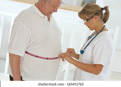 Woman doctor examining an obese patient.