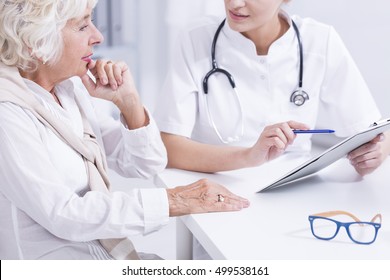 Woman Doctor Explaining The Medical Results To The Senior Woman