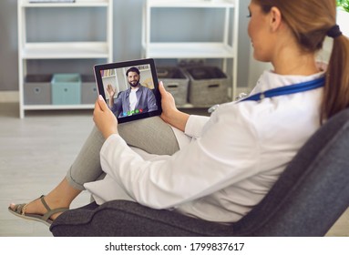 Woman Doctor Greeting Student During Online Lesson On Clipboard Screen