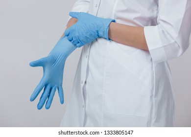 Woman doctor hands wears medical latex blue gloves, close-up - Shutterstock ID 1333805147