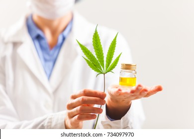 Woman Doctor Holding A Cannabis Leaf And Oil.alternative Medicine