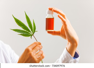 Woman Doctor Holding A Cannabis Leaf And Oil.alternative Medicine