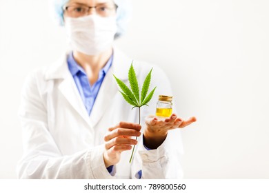 Woman Doctor Holding A Cannabis Leaf And Oil