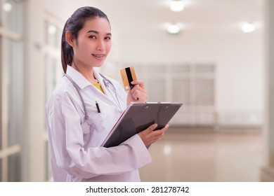 Woman Doctor Holding Card In Hospital