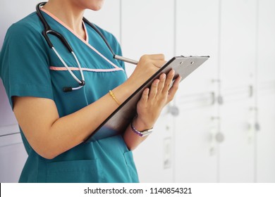 Woman doctor holding a chart in a modern office