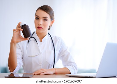 Woman Doctor Holding Package With Pills. Hospital Worker With Vitamins