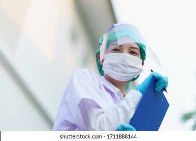 Woman Doctor, Holding Patient Report Form Folder, Outdoor Portrait, Coronavirus COVID-19 Pandemic.