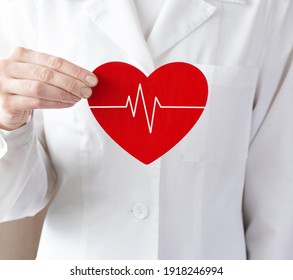 Woman doctor holding a red heart. Medical help, prophylaxis or insurance concept. Cardiology care, health, protection
