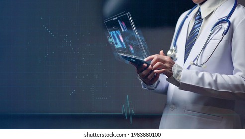 Woman doctor holding smart device with holographic, futuristic head up display on smart device for medical examination and medical diagnosis - Powered by Shutterstock