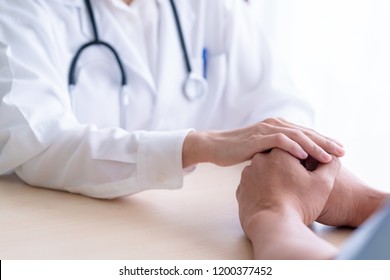 Woman doctor holds hands for male patients to encourage. - Shutterstock ID 1200377452