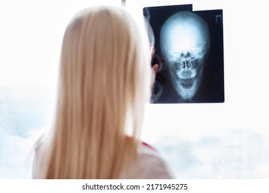 Woman Doctor Looking At X-Ray Radiography.