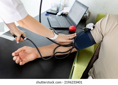 Woman Doctor Measures By Tonometer Blood Pressure For Patient In Clinic. Test, Cardiovascular Disease Diagnostic, Healthcare, Medical Service.