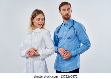 woman doctor next to an assistant medicine hospital gray background