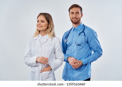 Woman doctor next to an assistant stand next to medicine