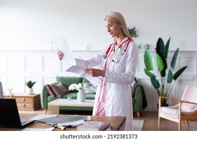 Woman Doctor In Office Reviewing Test Results