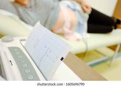Woman at doctor office whit ctg or ecg.  Ctg pregnancy at hospital. 