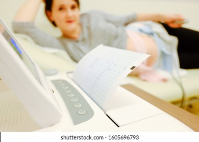 Woman at doctor office whit ctg or ecg.  Ctg pregnancy at hospital. 