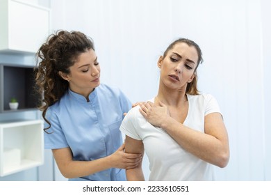 Woman doctor osteopath in medical uniform fixing woman patients shoulder and back joints in manual therapy clinic during visit. Professional osteopath during work with patient concept - Shutterstock ID 2233610551