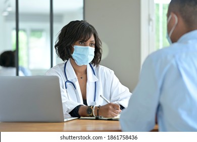 Woman Doctor With Patient In Office, Check-up For 19-ncov 