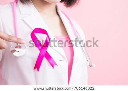 woman doctor pointing pink ribbon with breast cancer prevent concept on the pink background