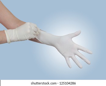 Woman Doctor Pulling On White Surgical Gloves.