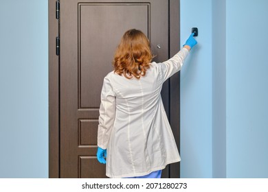 Woman doctor rings the apartment doorbell when visiting a patient home.
