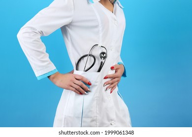 woman doctor with stethoscope on blue background with copy space - Shutterstock ID 1999061348