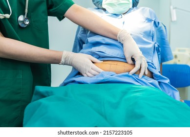 Woman Doctor Using A Hand To Hold The Belly Fat Of Obese Woman Patients, Who Received Treatment For Abdominal Fat Reduction Surgery From Obesity, To People Health Care And Surgery Concept.