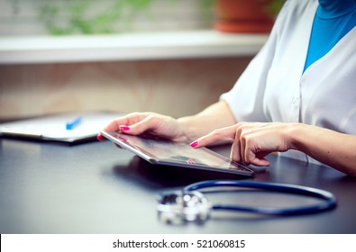 Woman Doctor Using Tablet Computer In Hospital