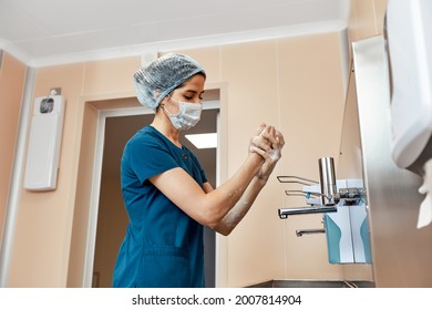 Woman doctor, washing her hands close-up, in the preoperative unit, disinfection of hands, plastic surgery - Powered by Shutterstock