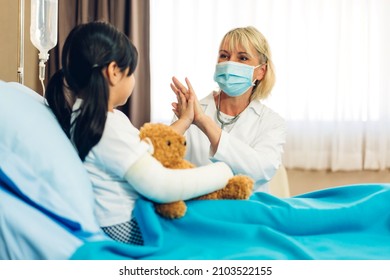 Woman Doctor Wearing Protective Mask Service Help Support Discussing And Consulting Talk To Little Girl Patient And Giving Hi Five Check Up Information In Hospital