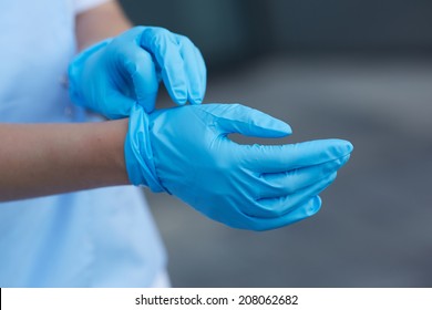 Woman Doctor Wears Medical Gloves 