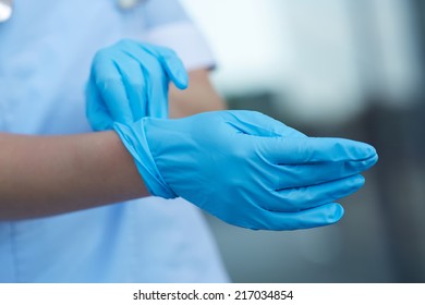 woman doctor wears medical gloves  - Shutterstock ID 217034854