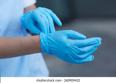 Woman Doctor Wears Medical Gloves 