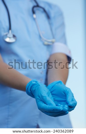 woman doctor wears medical gloves 