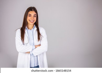 Woman doctor in white uniform standing with crossed arms. isolated female portrait. Portrait of happy successful female doctor. Hospital worker looking at camera and smiling, studio, gray background - Powered by Shutterstock