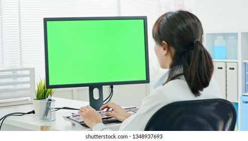 Woman Doctor Work And Use A Computer With Green Screen Monitor In The Clinic