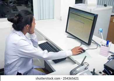 Woman Doctor Working On Computer In Office Of Hospital. Medical Staff Looking At Monitor.