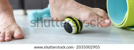 Woman does exercises with ball to correct foot defects and flat feet