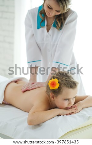 Woman Does Massage To The Little Girl Woman Does Massage To The Little Girl