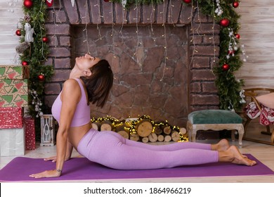 Woman Does Yoga At Home, New Year Christmas Background. 