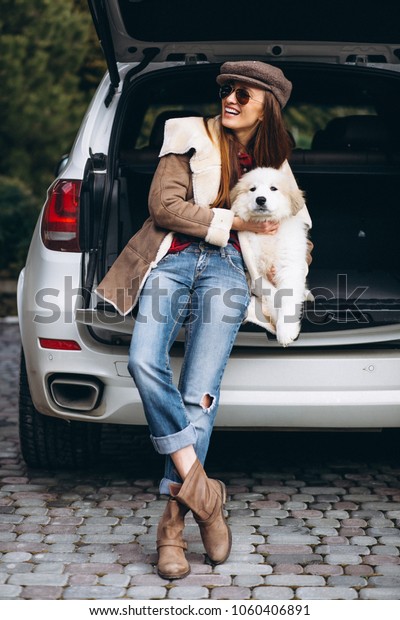 Woman with dog in\
car