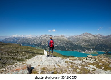 Woman And Dog Hiking In Switzerland