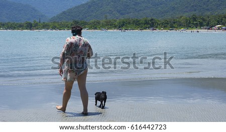 woman and dog on the Brazilian beach