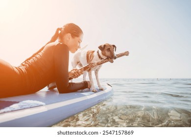 Woman Dog Paddleboard Sunset Ocean: Woman and dog enjoying paddleboarding at sunset. - Powered by Shutterstock