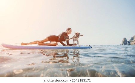 Woman Dog Paddleboarding Ocean - A woman and her dog paddleboard together on a sunny day in the ocean. - Powered by Shutterstock