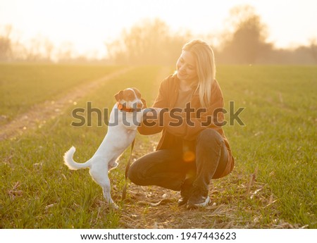 Similar – Image, Stock Photo Loving young woman offered a paw by her dog