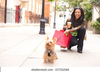 Woman With Dog And Shopping Bags