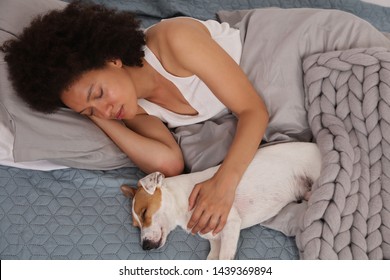 Woman and dog sleeping together. Pet Allergies concept. Cozy style