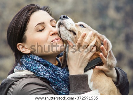 Woman and dog tender hugs